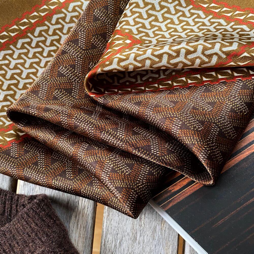 Close-up view highlighting the fine Japanese print and texture of a pure mulberry silk square scarf.