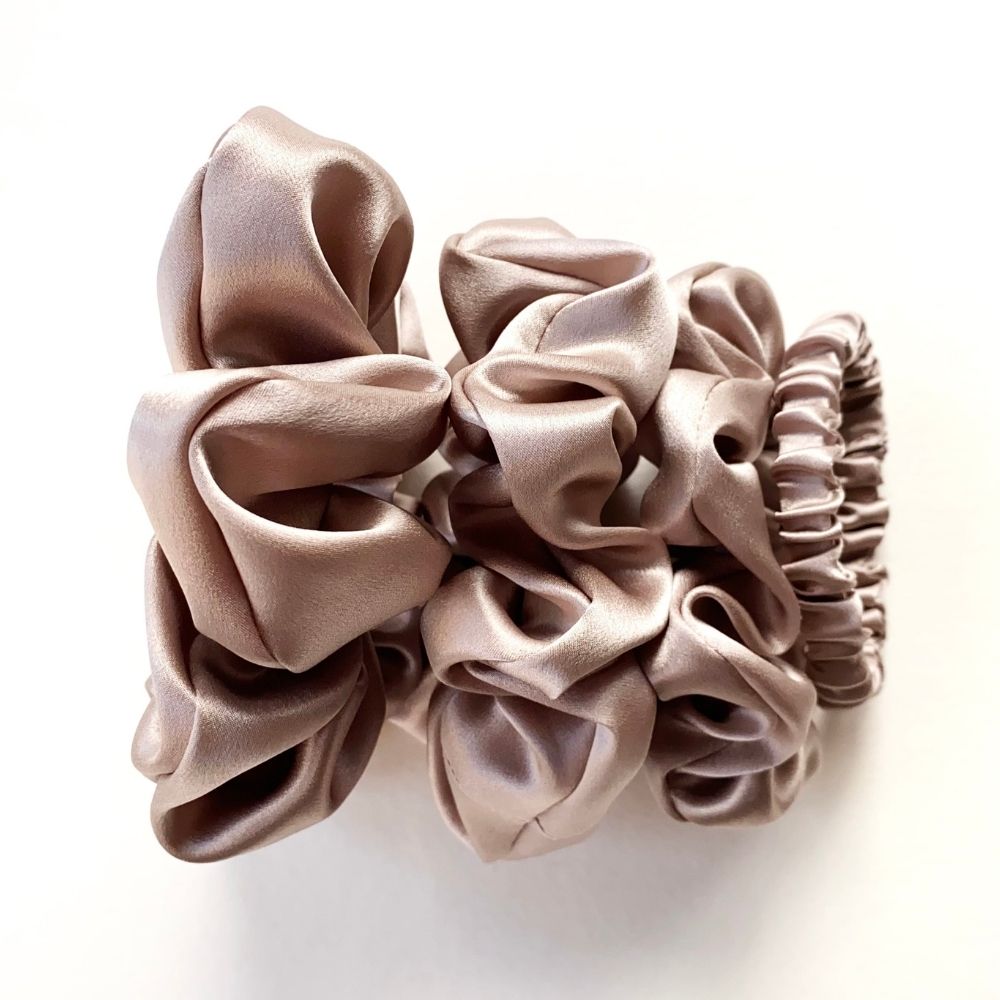 Set of taupe mulberry silk satin scrunchies and hair ties on a white background