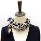 Mannequin wearing a black ivory leopard print mulberry silk neck scarf with a white background