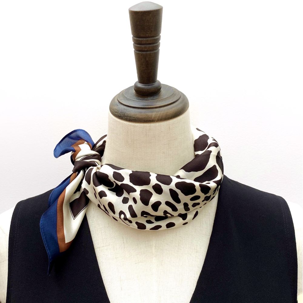 Mannequin wearing a black ivory leopard print mulberry silk neck scarf with a white background