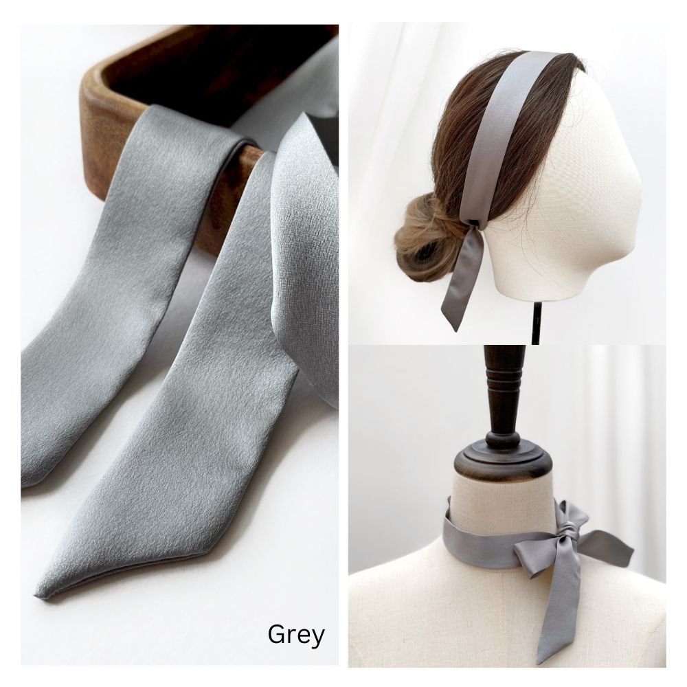 Gray mulberry silk skinny scarf used as a self tied headband and necktie on a mannequin and flat surface.