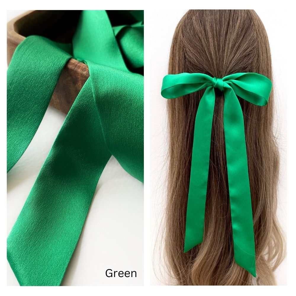 A green mulberry silk satin skinny ribbon scarf tied as a hairbow, styled against a crisp white background.