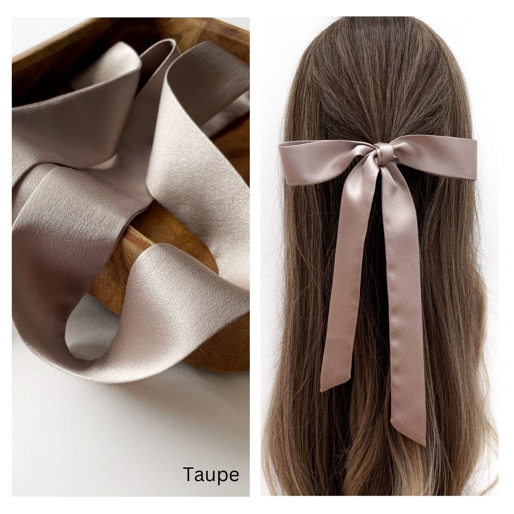 A taupe mulberry silk satin skinny ribbon scarf tied as a hairbow, styled against a crisp white background.