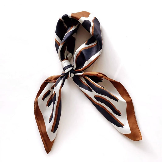 animal print mulberry silk twill neckerchief in black white and brown placed on white background