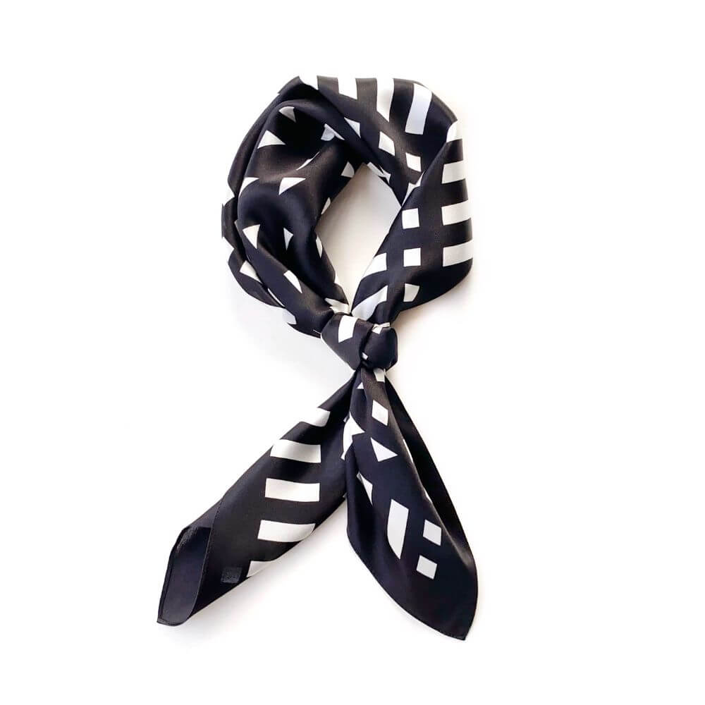 Black and white geometric mulberry silk square scarf on a white background