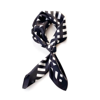 Black and white geometric mulberry silk square scarf on a white background