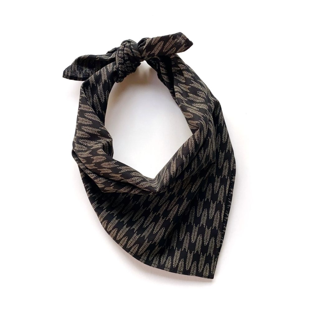 A black arrow print japanese cotton square scarf, tied in a knot and displayed on a clean white background.