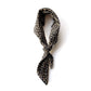 A black Japanese cotton neck scarf with a dense beige floral print, tied in a knot and displayed against a clean white background.