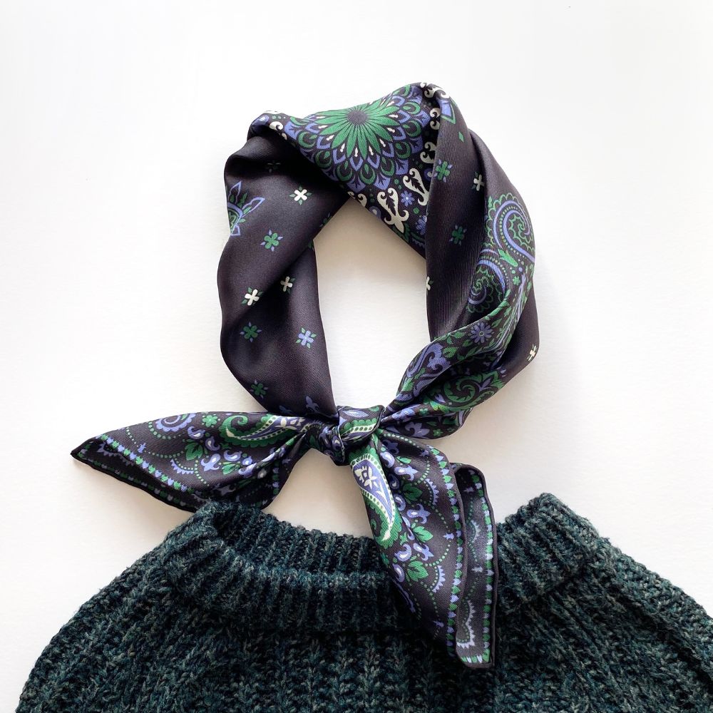 Dark green knitted top with a paisley patterned black and green mulberry silk twill neck bandana scarf on a white background