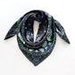 Green paisley patterned black mulberry silk square scarf on a white background