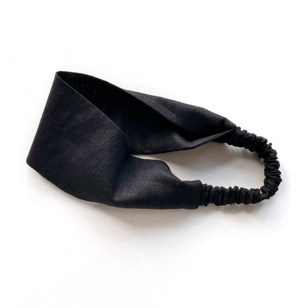 Black linen headband on a white background