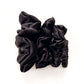Black mulberry silk scrunchies and hair ties on a white background