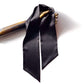Black silk satin scarf draped over a wooden hand on a white background