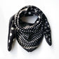 Black and white polka dot and paisley print mulberry silk square scarf displayed on a white background.