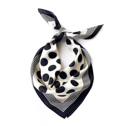 Black and white polka dot silk scarf on a white background