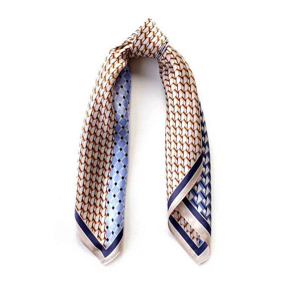 Blue & caramel geometric patterned silk scarf on a white background