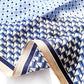 close up of the silk scarf with blue and white geometric pattern 