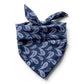 Blue paisley print mulberry silk square scarf tied at the back, placed on a white background