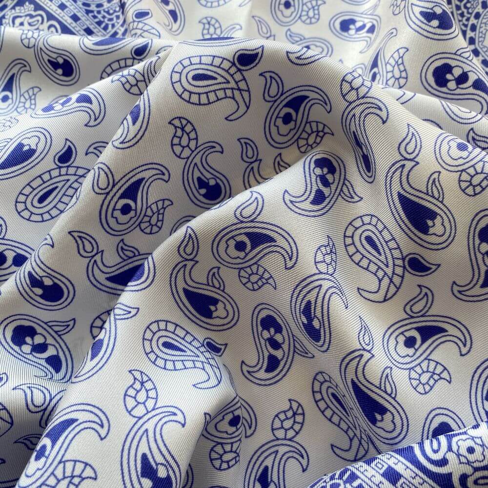 Close-up of blue and white geometric paisley pattern mulberry silk square scarf