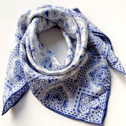 Blue and white geometric paisley pattern mulberry silk square scarf on a white background
