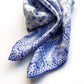 Blue and white geometric paisley pattern mulberry silk square scarf swirled on a white background