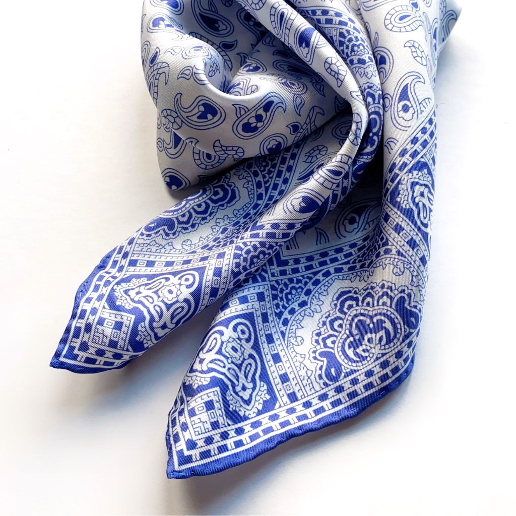 Blue and white geometric paisley pattern mulberry silk square scarf swirled on a white background