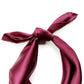 Burgundy mulberry silk satin scarf tied in a bow on a white background