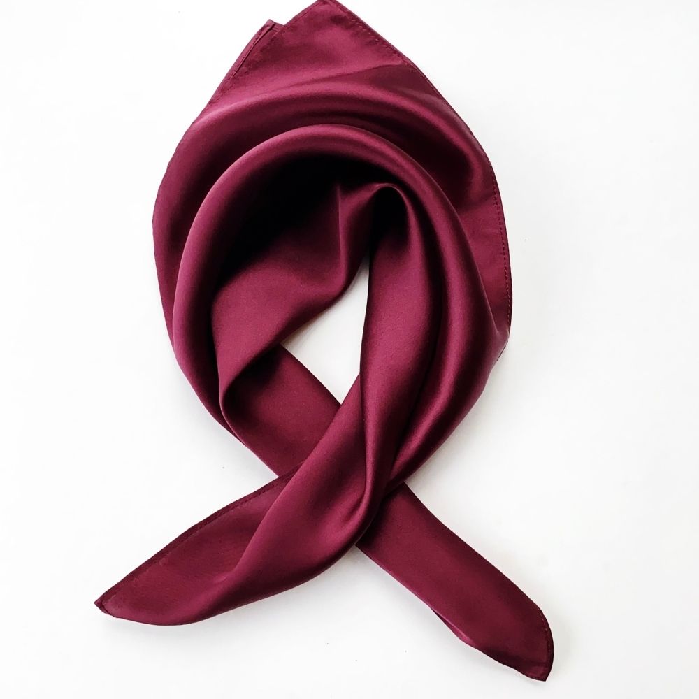 Maroon silk scarf on a white background