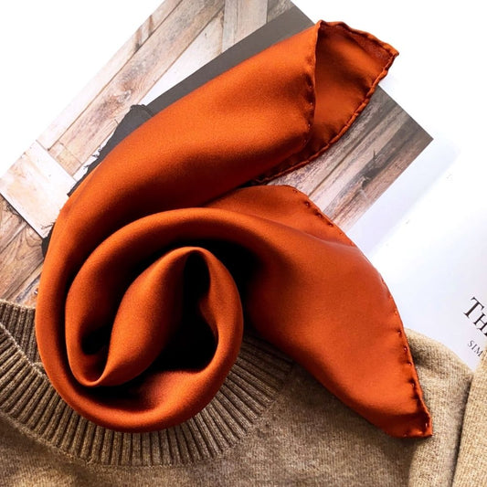 Burnt orange silk satin scarf styled with knit sweater for autumn outfit