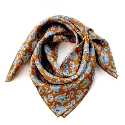 Caramel orange brown paisley patterned mulberry silk square bandana scarf on a white background