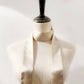 A champagne beige coloured mulberry silk satin skinny scarf wrapped around the mannequin's neck