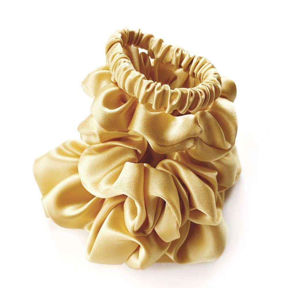 soft yellow mulberry silk satin scrunchies on a white background