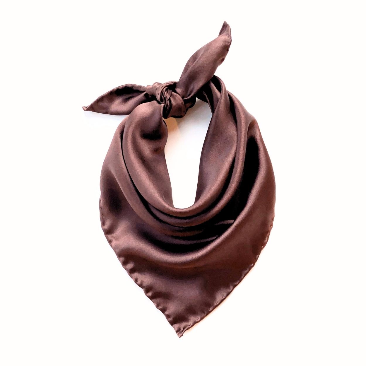A hand rolled hem chocolate brown mulberry silk square scarf tied in a knot, displayed against a solid white background.