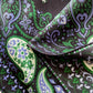 Close-up of green and purple paisley pattern mulberry silk twill square scarf