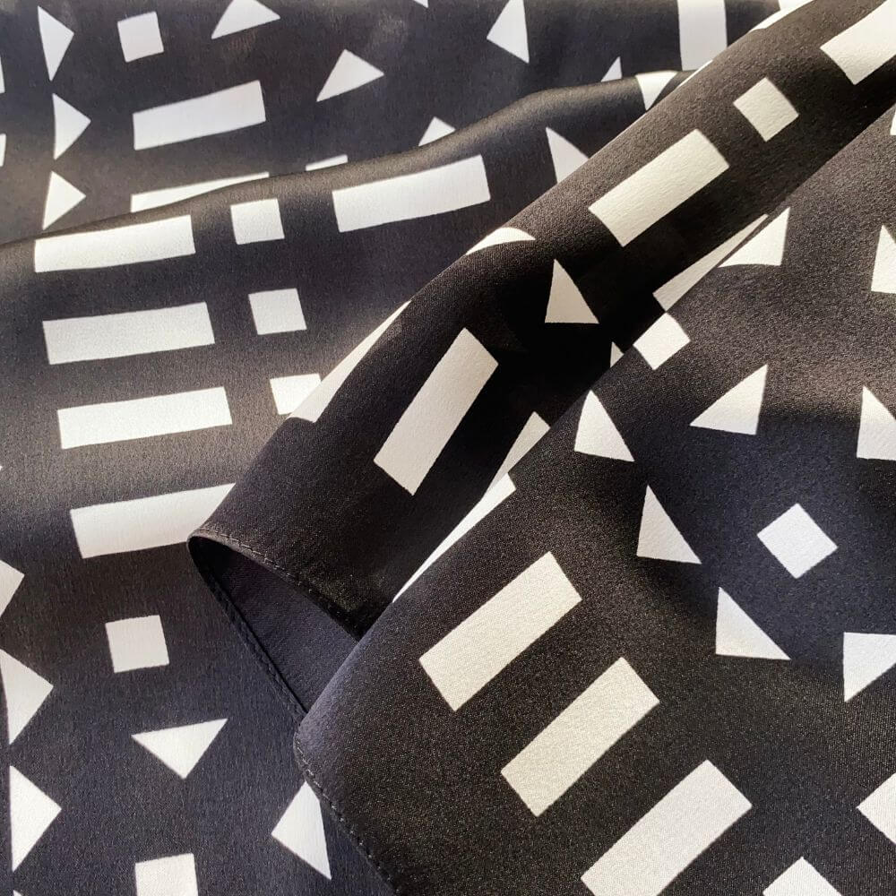 Close-up of black and white geometric mulberry silk square scarf