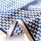 close up of the mulberry silk square scarf with blue and white geometric pattern 