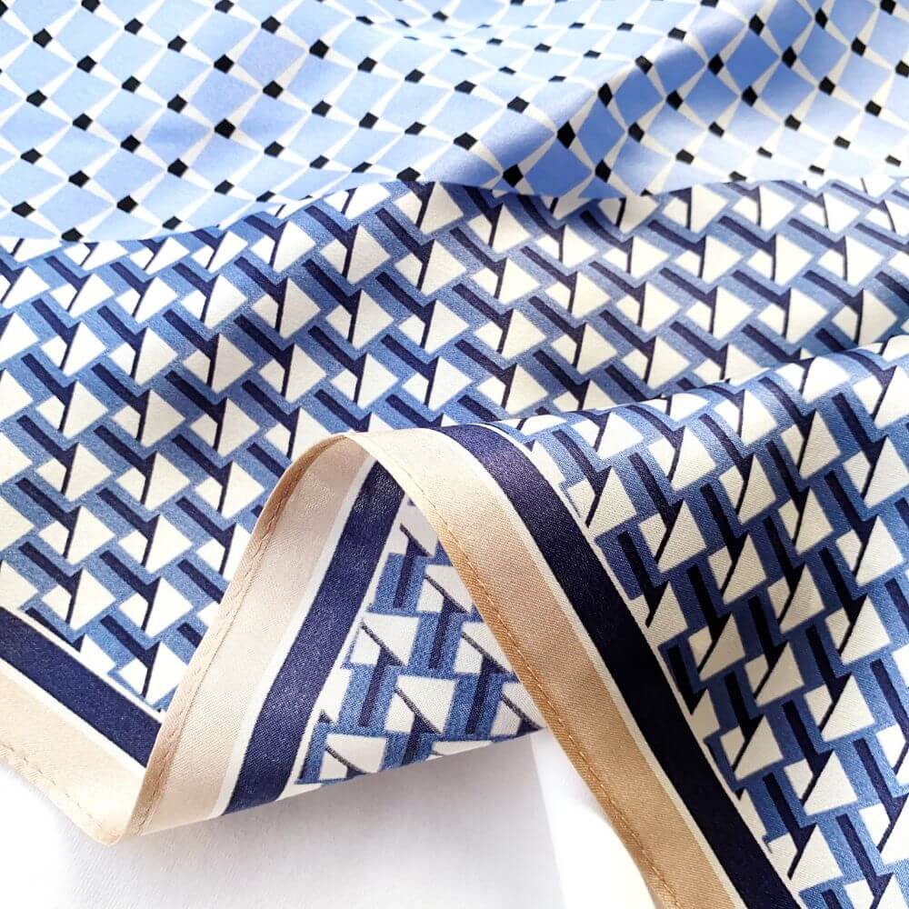 close up of the mulberry silk square scarf with blue and white geometric pattern 