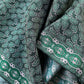Close-up of green and white paisley print mulberry silk square scarf
