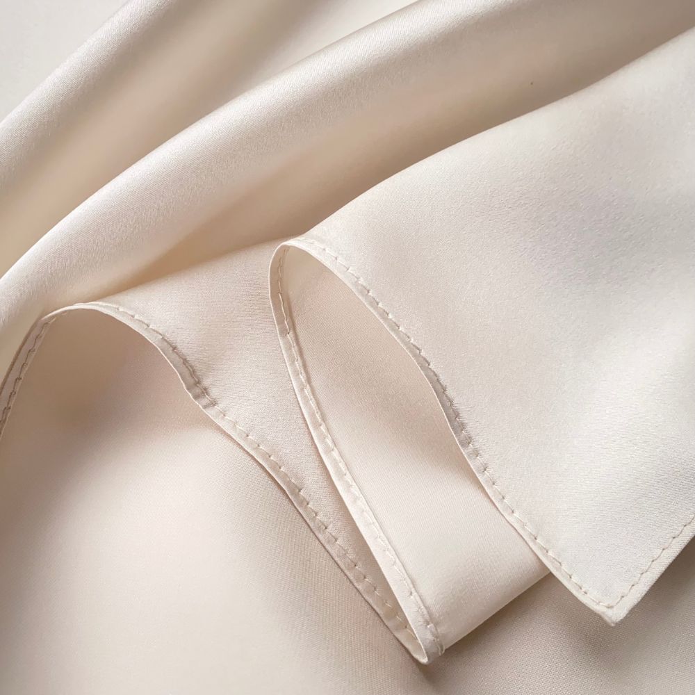 closed up of a light beige mulberry silk square scarf