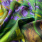 Colorful mulberry silk scarf with floral design in green, purple, and yellow.