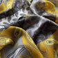close up of the yellow grey paisley patterned mulberry silk bandana scarf