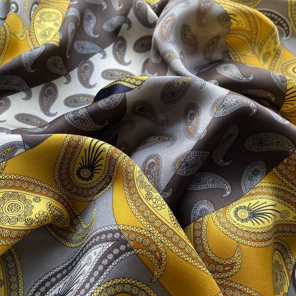 close up of the yellow grey paisley patterned mulberry silk bandana scarf