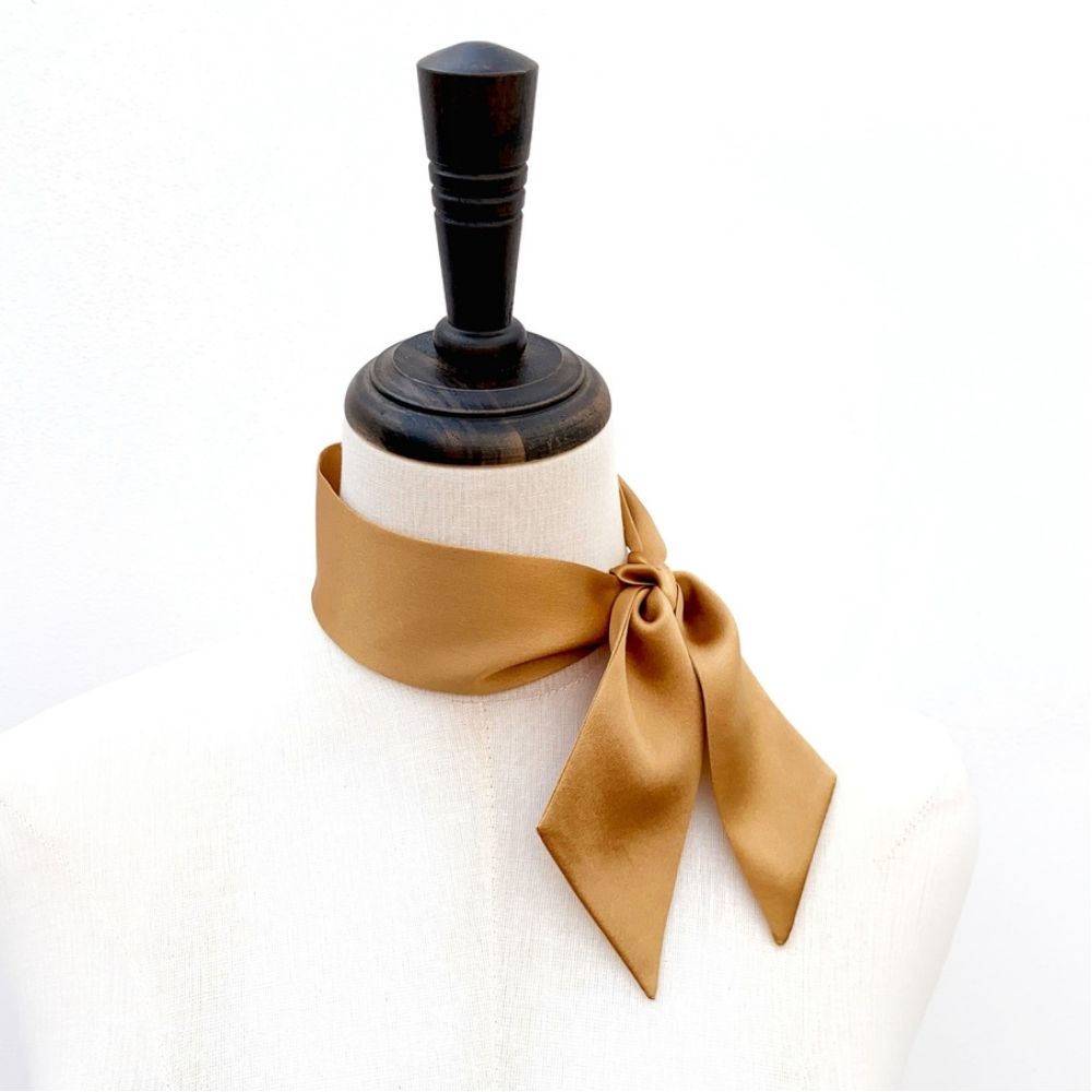 copper brown mulberry silk satin skinny scarf tied around mannequin's neck