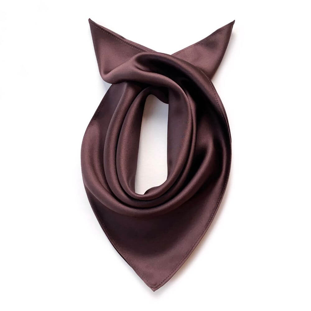 Brown silk scarf folded neatly on a white background