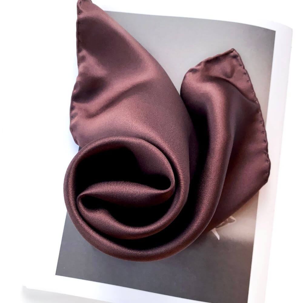 Close-up of a brown silk scarf on a white background