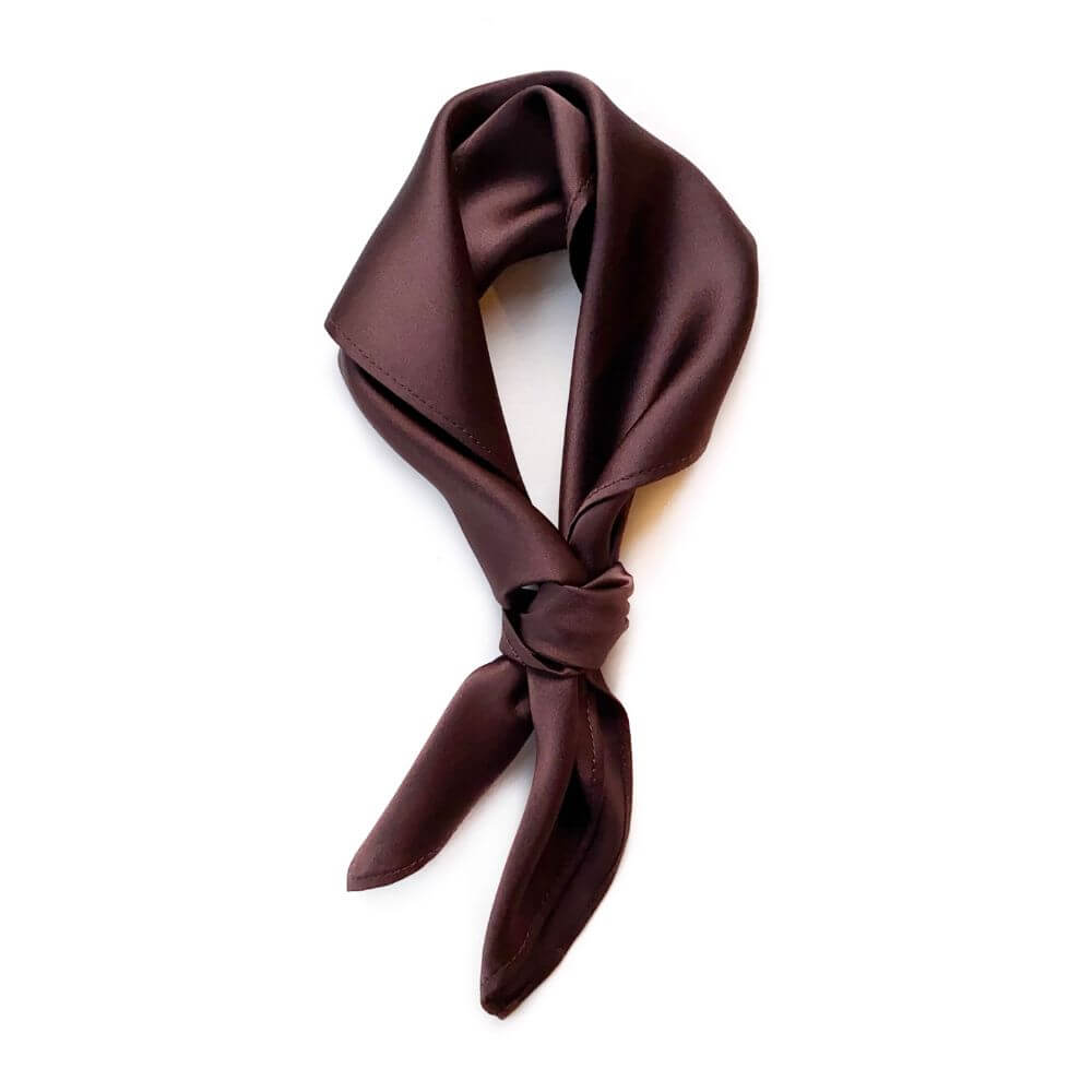 Brown silk scarf tied in a knot on a white background