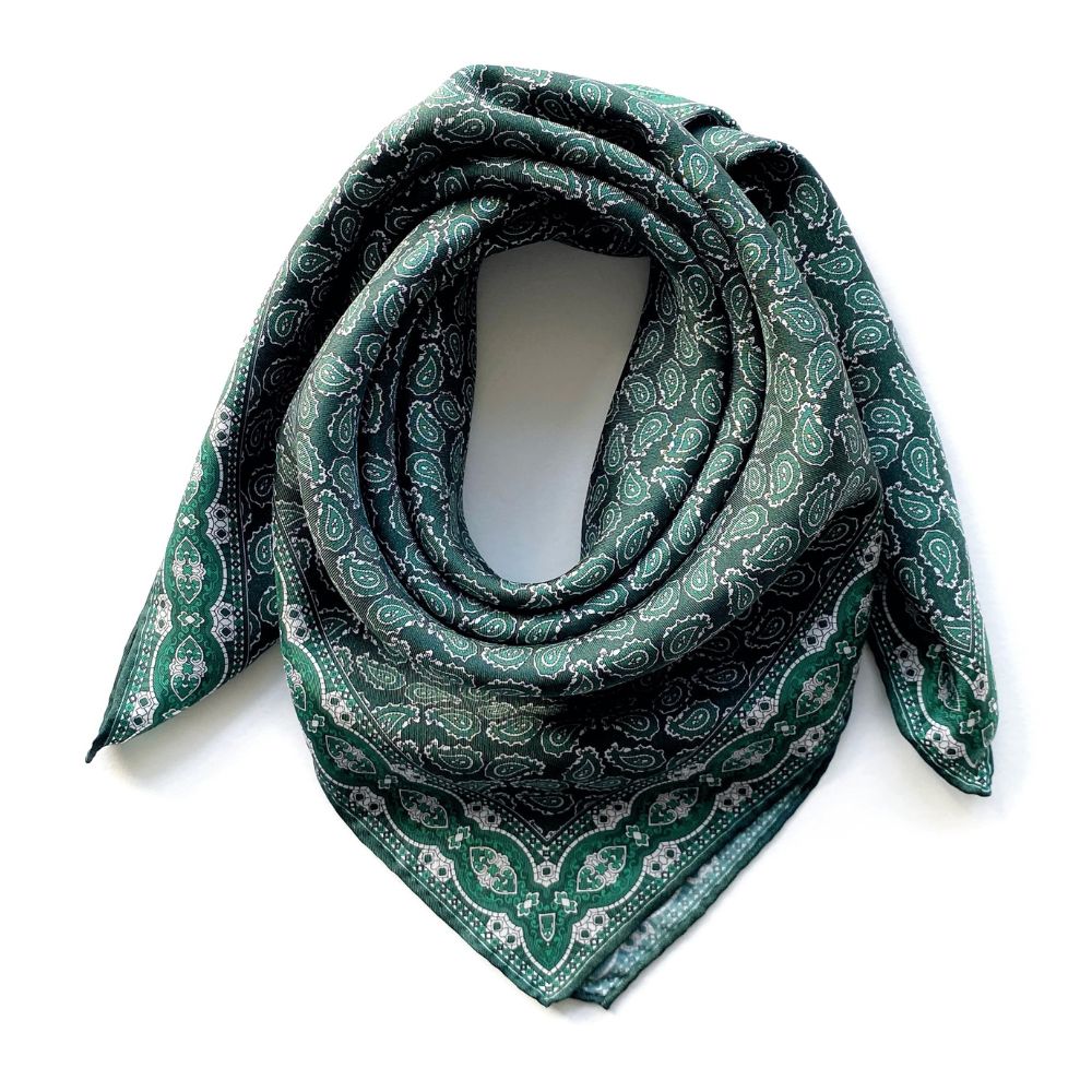 Green paisley patterned mulberry silk square bandana scarf on a white background