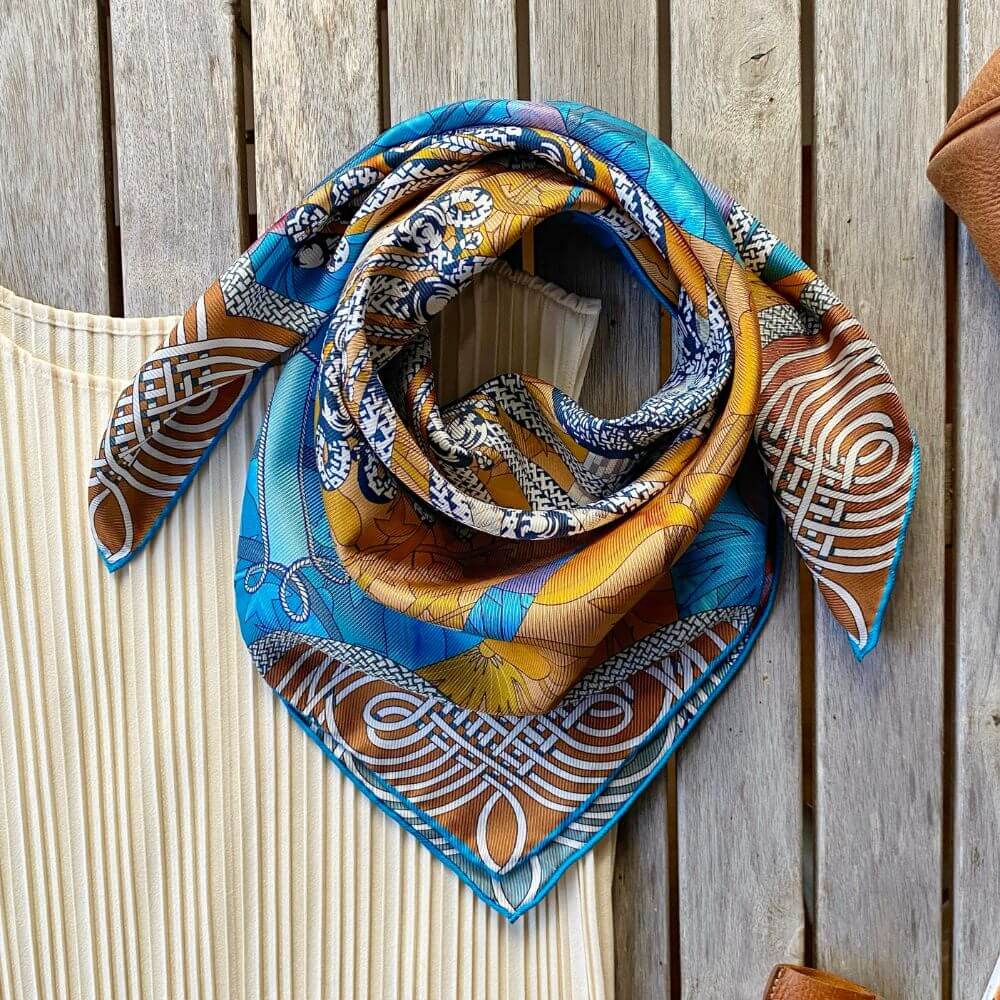 yellow and blue colourful double-sided mulberry silk bandana scarf on a table