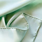 Close-up of light green silk scarf with a soft texture