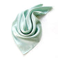 Light blue mulberry silk satin scarf on a white background
